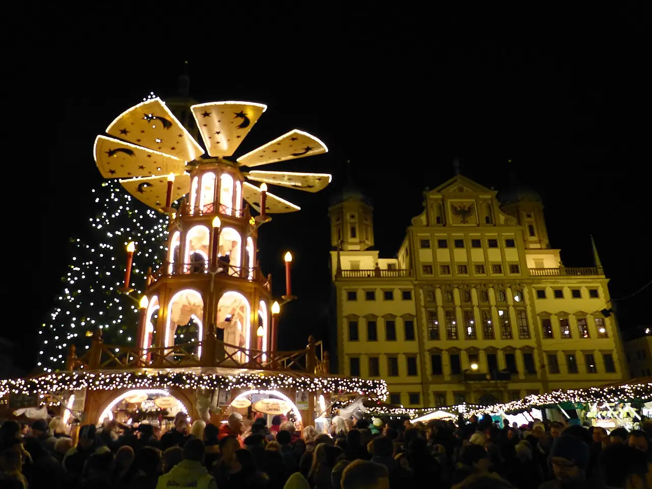 Christmas pyramid, Christmas tree and the illuminated town hall in the evening