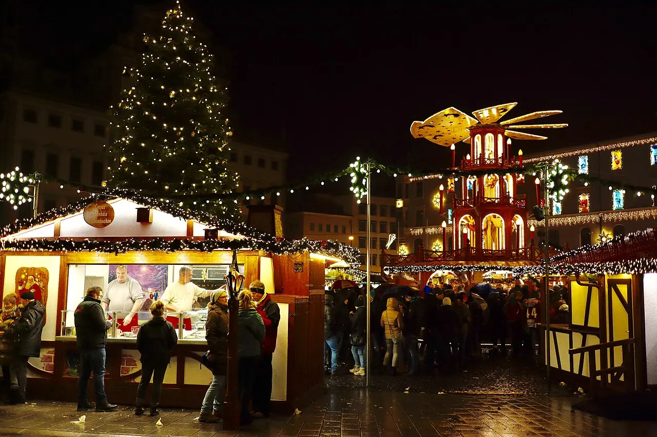 Snack stall, Christmas tree and Christmas pyramid on Rathausplatz at night