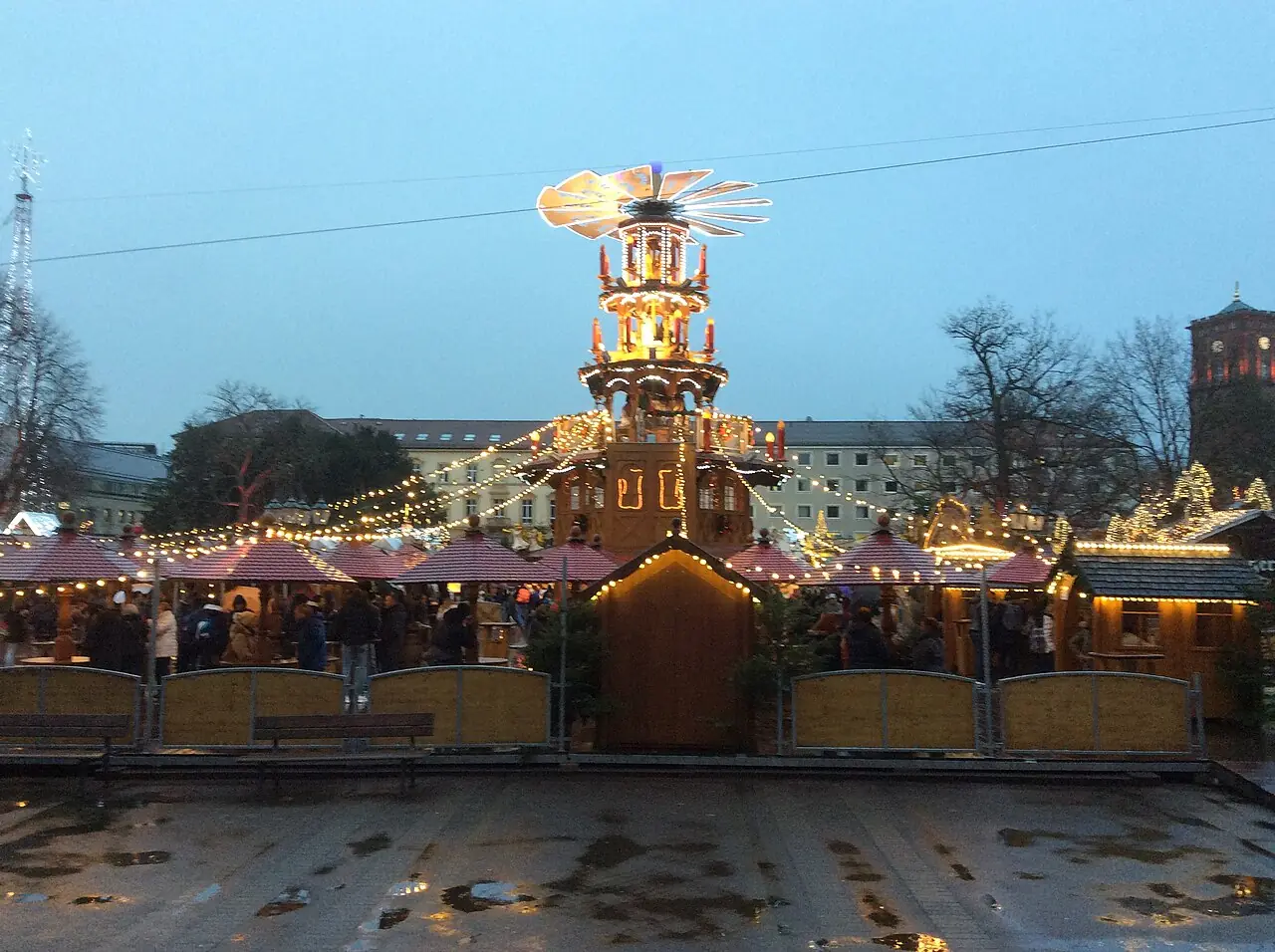 Mulled wine pyramid and stalls on Marktplatz at dusk, the town hall tower on the right