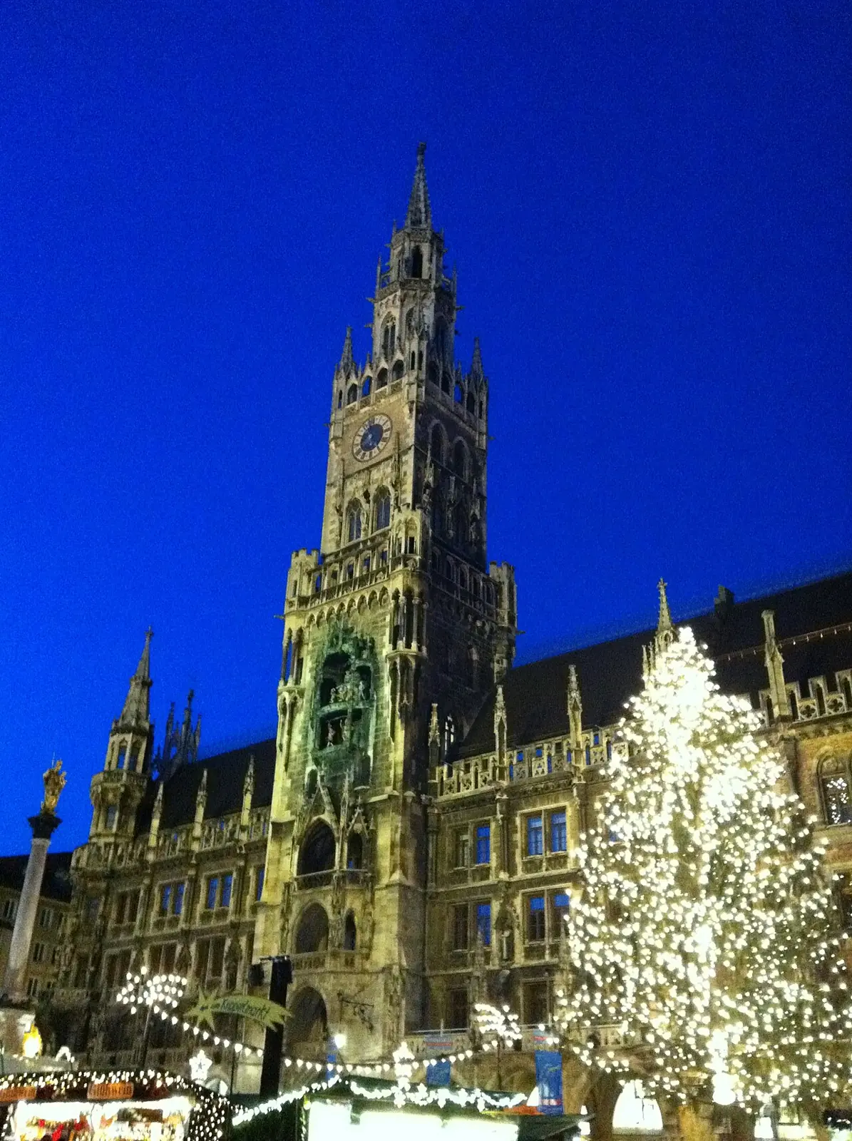 New Town Hall at blue hour with illuminated Christmas tree and market stalls (portrait format)