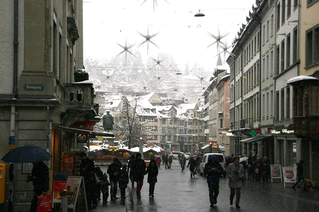 Stars above Marktgasse in falling snow, market stalls by the Vadian monument in the background (2012)