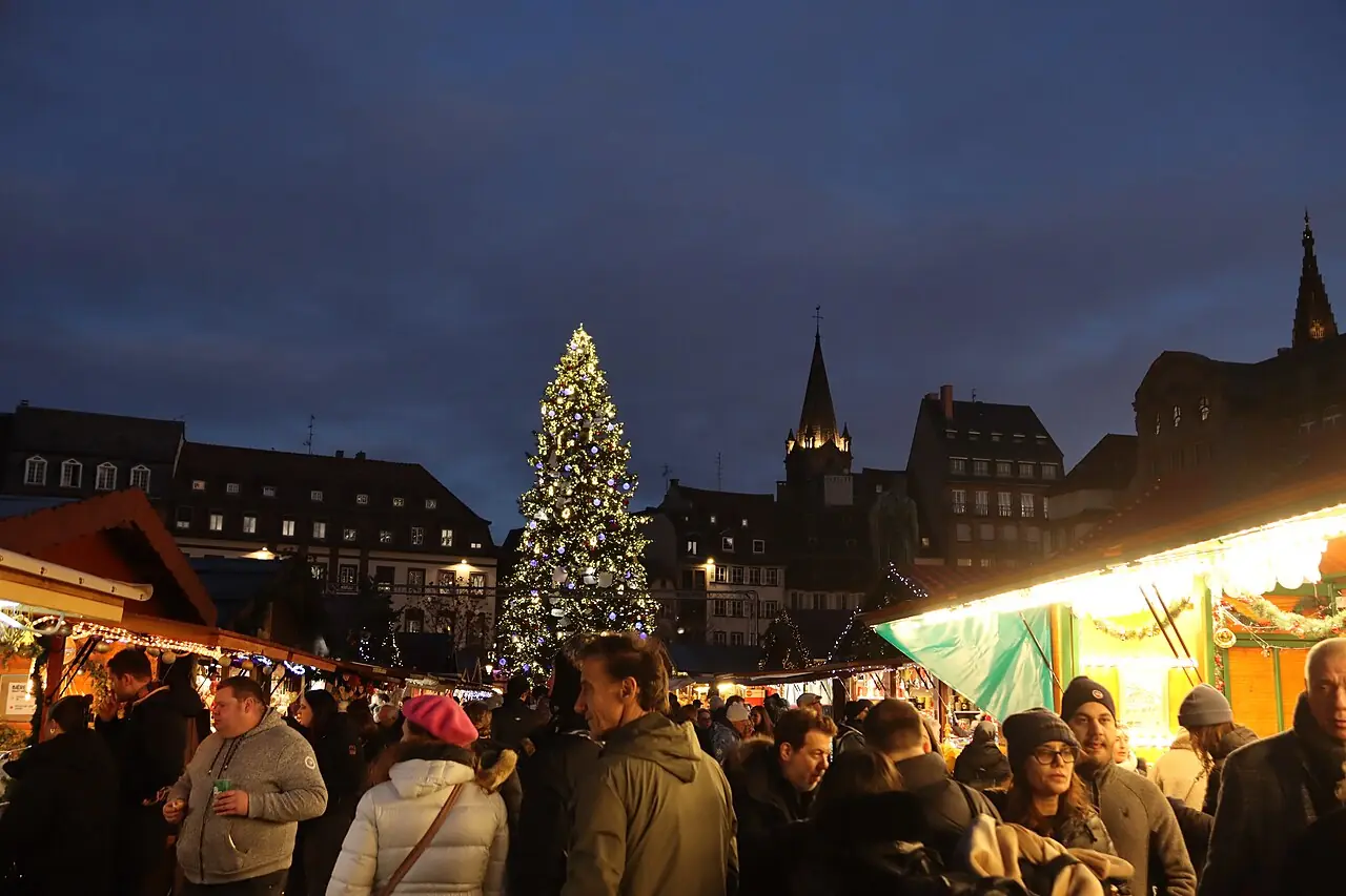 Grand Sapin on Place Kléber at blue hour, chalets and visitors in front