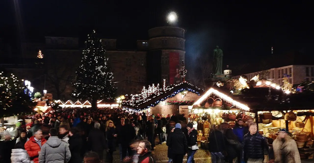Schillerplatz in the evening with Christmas tree, Schillerdenkmal and Altes Schloss, stalls and visitors in front
